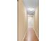 Hallway featuring wood-look floors leading to rooms at the end of the hall at 12407 Ne 48Th Loop, Oxford, FL 34484