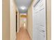 Inviting hallway with wood-look flooring and neutral paint leading to other rooms at 12407 Ne 48Th Loop, Oxford, FL 34484