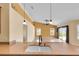 Kitchen with granite countertops, wood cabinets, and an open view to the dining and living area at 12407 Ne 48Th Loop, Oxford, FL 34484