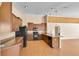 Modern kitchen featuring wood cabinetry and an open design that seamlessly connects to the living area at 12407 Ne 48Th Loop, Oxford, FL 34484