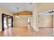 Open concept living room with light-colored walls and wood flooring, perfect for entertaining at 12407 Ne 48Th Loop, Oxford, FL 34484