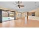 Open concept living room with access to a screened-in pool area and a view of the kitchen at 12407 Ne 48Th Loop, Oxford, FL 34484