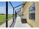 Screened patio area, ideal for outdoor seating, overlooks a verdant lawn at 12407 Ne 48Th Loop, Oxford, FL 34484