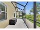 Screened in patio with adjacent manicured lawn at 12407 Ne 48Th Loop, Oxford, FL 34484