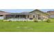 View of the screened in pool, lush yard, and patio of the house at 12407 Ne 48Th Loop, Oxford, FL 34484