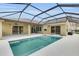 Screened-in pool with covered patio, outdoor ceiling fans and multiple access points at 12407 Ne 48Th Loop, Oxford, FL 34484