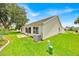 The backyard features a lawn and patio accessible from the house at 1401 Madrigal Ln, Lady Lake, FL 32159