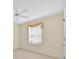 Sunny bedroom with a neutral color scheme, a window with curtains, and a ceiling fan at 1401 Madrigal Ln, Lady Lake, FL 32159