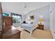 Cozy bedroom showcasing a vaulted ceiling, ample natural light, and classic wooden furnishings at 1401 Madrigal Ln, Lady Lake, FL 32159