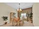 Traditional dining room featuring wood table with seating and natural light at 1401 Madrigal Ln, Lady Lake, FL 32159