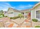 Inviting covered front porch with seating area and decorative stone landscaping at 1401 Madrigal Ln, Lady Lake, FL 32159