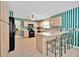 Bright kitchen showcasing cabinets, an island with seating, and modern black appliances at 1401 Madrigal Ln, Lady Lake, FL 32159