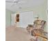 A seating area featuring comfortable armchairs, a ceiling fan, and a window at 1401 Madrigal Ln, Lady Lake, FL 32159