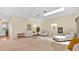 Spacious living room with neutral carpet, ceiling fan, and comfortable seating at 1401 Madrigal Ln, Lady Lake, FL 32159