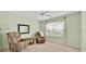 Inviting living room area with comfortable armchairs, a window, and a ceiling fan at 1401 Madrigal Ln, Lady Lake, FL 32159