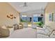 Bright sunroom featuring neutral tones, ceiling fan, and door to the back yard at 1401 Madrigal Ln, Lady Lake, FL 32159