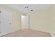 Neutral bedroom features carpet, ceiling fan, and door to hall and closet space at 1401 Madrigal Ln, The Villages, FL 32159