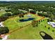 Aerial view showcases the pond, greenery, and home within the property's boundaries at 14325 Manchester Ave, Groveland, FL 34736