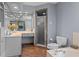 Bright bathroom with a large vanity, tiled shower, and soaking tub for relaxation at 14325 Manchester Ave, Groveland, FL 34736