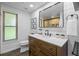 Modern bathroom featuring shiplap walls, black fixtures and a quartz countertop vanity at 14325 Manchester Ave, Groveland, FL 34736