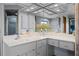 Bathroom featuring a long vanity with a mirrored wall and a glimpse of the shower and tub at 14325 Manchester Ave, Groveland, FL 34736