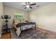 Bedroom featuring hardwood floors, a ceiling fan, and lots of light from the window at 14325 Manchester Ave, Groveland, FL 34736