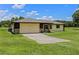 A well-maintained home featuring a two-car garage, stone accents, and a neatly manicured lawn at 14325 Manchester Ave, Groveland, FL 34736
