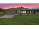 Charming single-story home with a well-manicured lawn and attached two-car garage at 14325 Manchester Ave, Groveland, FL 34736