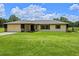 Charming single-story home with a spacious front yard and a well-kept lawn at 14325 Manchester Ave, Groveland, FL 34736