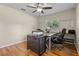 Spacious office featuring hardwood floors, a ceiling fan and dual windows at 14325 Manchester Ave, Groveland, FL 34736