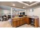 Open-concept kitchen with granite countertops and view to living room with hardwood floors at 14325 Manchester Ave, Groveland, FL 34736