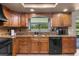 Updated kitchen with granite counters, stainless steel appliances, and tiled backsplash at 14325 Manchester Ave, Groveland, FL 34736