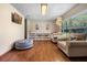 Cozy living room featuring hardwood floors, soft lighting, and a comfortable chair at 14325 Manchester Ave, Groveland, FL 34736