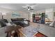 Open-concept living room with hardwood floors, fireplace, and a comfortable sectional sofa at 14325 Manchester Ave, Groveland, FL 34736