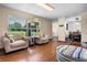Bright living room featuring cozy seating and large windows with a scenic outdoor view at 14325 Manchester Ave, Groveland, FL 34736