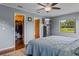 This spacious bedroom features an ensuite bath, a walk-in closet and a ceiling fan at 14325 Manchester Ave, Groveland, FL 34736