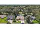 An aerial view of home with mature landscaping, verdant lawns, and neighborhood surroundings at 1512 Cervantes Pl, Lady Lake, FL 32159