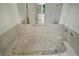 Luxurious marble-clad bathtub featuring a designer faucet, providing an oasis for relaxation and comfort at 1512 Cervantes Pl, Lady Lake, FL 32159
