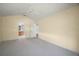 Spacious bedroom features neutral carpet and provides access to the bathroom and additional living spaces at 1512 Cervantes Pl, Lady Lake, FL 32159