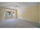 Bright bedroom featuring large windows, neutral carpet, and a fan offering ample natural light at 1512 Cervantes Pl, Lady Lake, FL 32159