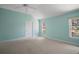 Bright bedroom features neutral carpet, high ceilings, fan, and a scenic view from the double window at 1512 Cervantes Pl, Lady Lake, FL 32159