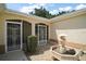 Up-close exterior shot of the front door entry and lovely front yard landscaping at 1512 Cervantes Pl, Lady Lake, FL 32159