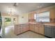 Bright kitchen with stainless steel appliances, plenty of cabinets, and a bay window with backyard views at 1512 Cervantes Pl, Lady Lake, FL 32159