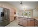 Spacious kitchen with stainless steel refrigerator, ample counter space, and backyard views from the breakfast nook at 1512 Cervantes Pl, Lady Lake, FL 32159
