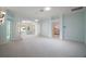 Spacious living room with neutral carpet, paint, and natural light; features columns and arches at 1512 Cervantes Pl, Lady Lake, FL 32159