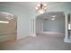 Large open living space with a view to the sunroom, kitchen, and front door entry at 1512 Cervantes Pl, Lady Lake, FL 32159
