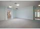 Open-concept living room with white trim, overhead lighting, and a view to other rooms in the home at 1512 Cervantes Pl, Lady Lake, FL 32159