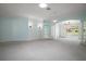 Large, open-concept living space with overhead lighting and white trim; features a view to the backyard at 1512 Cervantes Pl, Lady Lake, FL 32159
