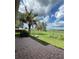 Brick patio with view of the fenced backyard and mature palm tree at 17329 Se 115Th Ter, Summerfield, FL 34491