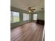 Bedroom with wood floors and 3 bright windows at 17329 Se 115Th Ter, Summerfield, FL 34491